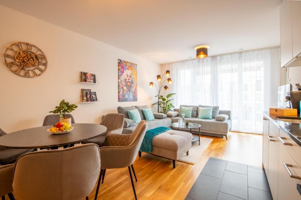 ein Wohnzimmer mit einem Tisch und einem Sofa in der Unterkunft Special EiNSTEiN II Apartment Basel, Messe Kleinbasel 10-STAR in Basel