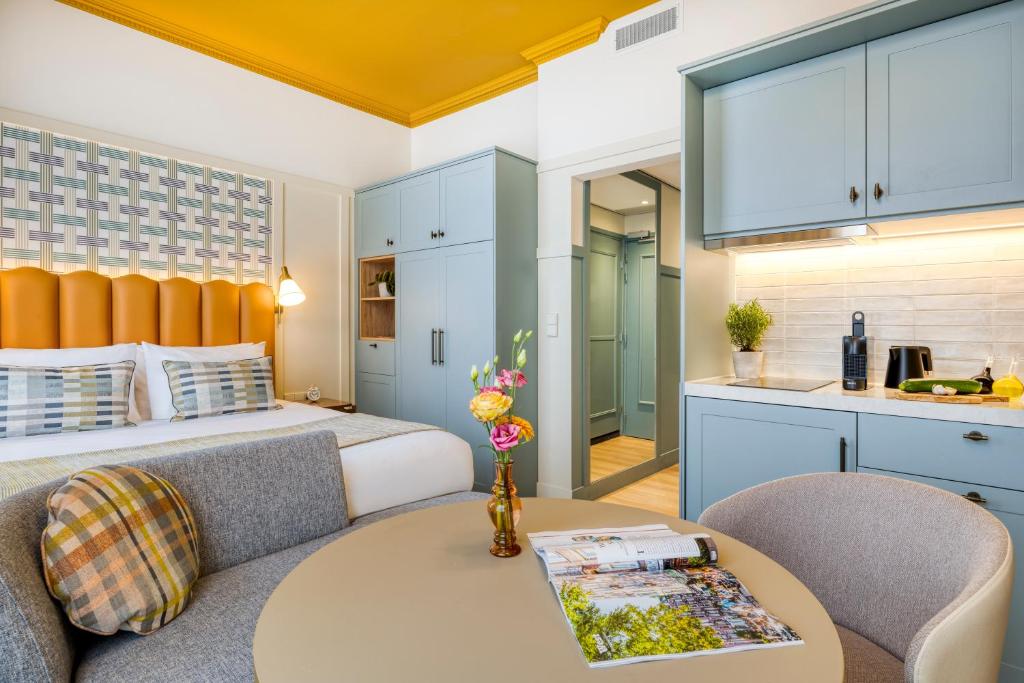 a bedroom with a bed and a table in a room at Citadines Canal Amsterdam in Amsterdam