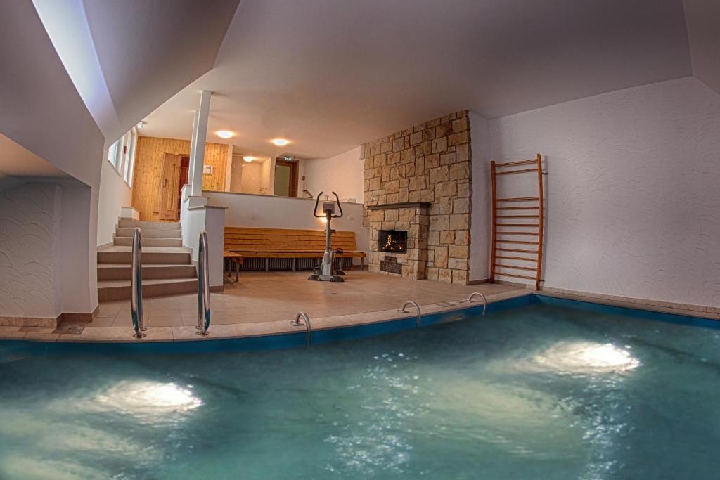 a pool of water in a room with a fireplace at Hotel Heldt in Bad Pyrmont