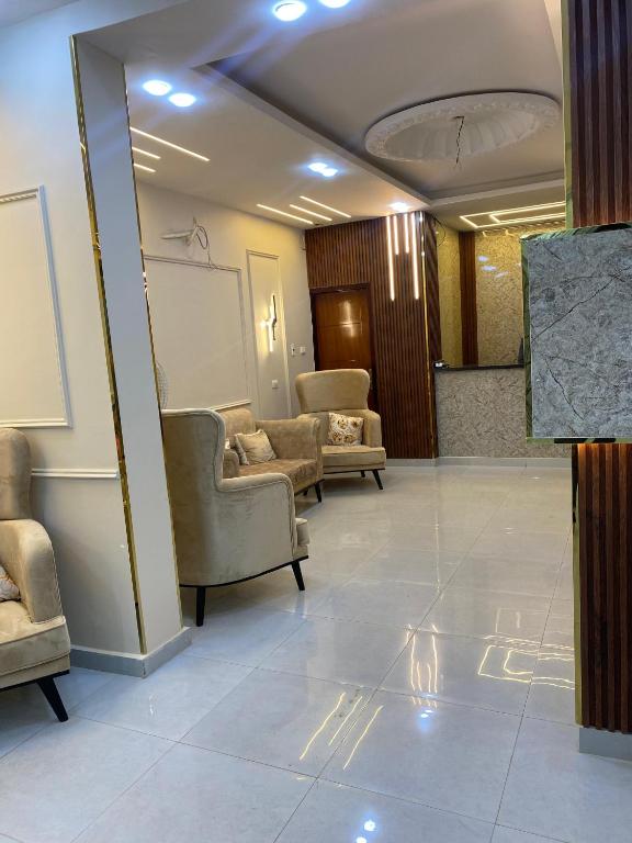a waiting room with chairs and a chalkboard on the wall at Explore Stars Pyramids View in Cairo