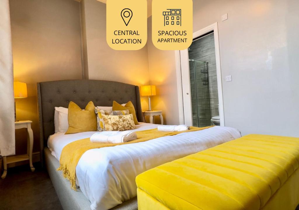 a bedroom with a large bed with yellow sheets at Central - Business Stays - Relocating in Harrogate