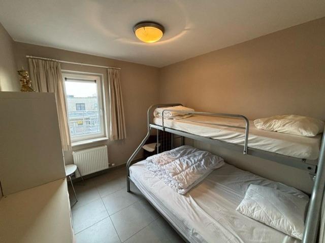 Dos literas en una habitación con ventana. en Walter Vilain 0503 - 5 min De La Plage, en Koksijde