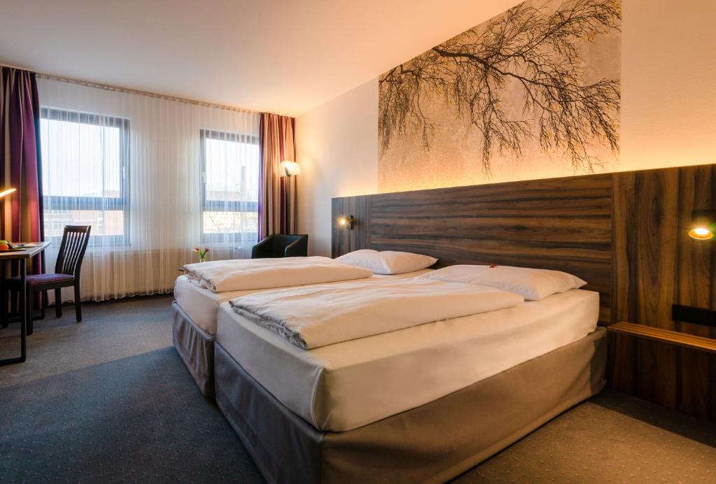 una habitación de hotel con dos camas en una habitación en City Hotel Fortuna Reutlingen, en Reutlingen