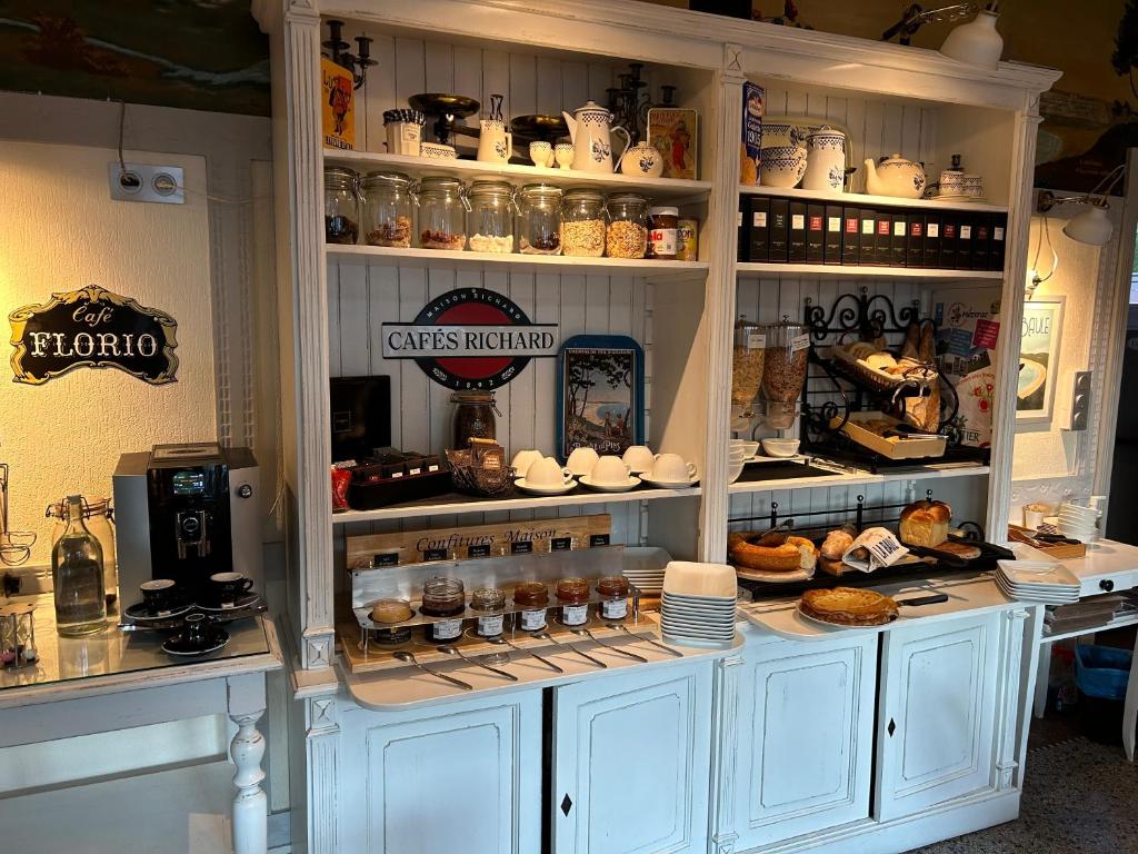 a kitchen with a hutch filled with lots of food at Hotel Ty Gwenn La Baule in La Baule