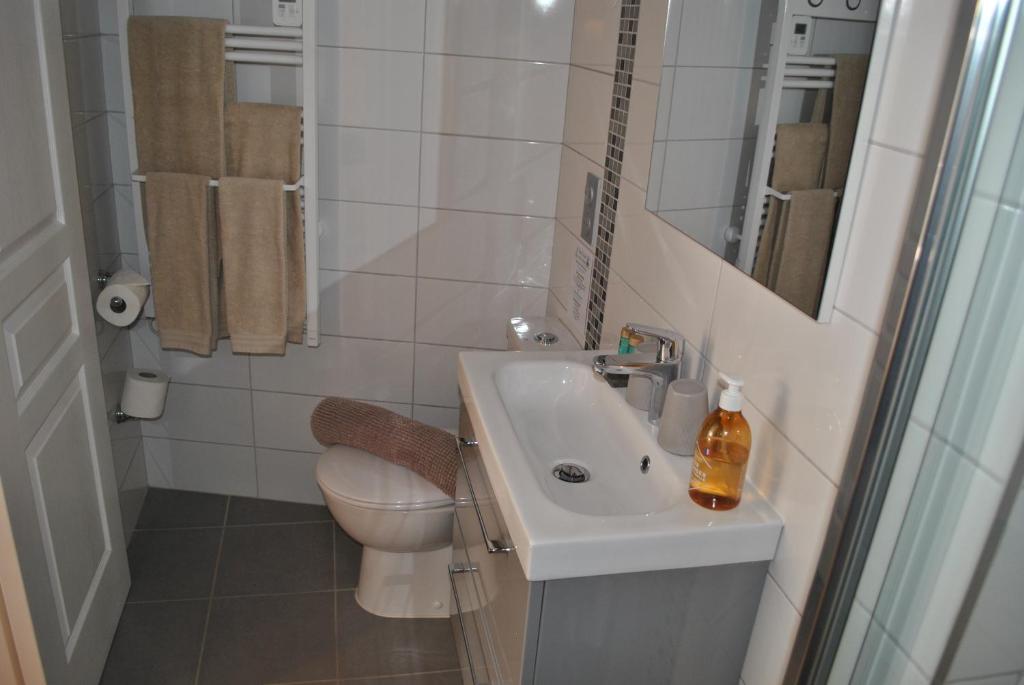 a small bathroom with a sink and a toilet at Hotel Ty Gwenn La Baule in La Baule