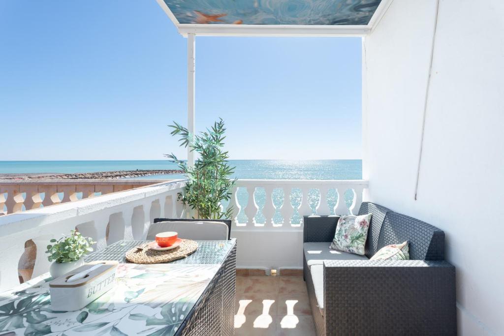 a balcony with a table and chairs and the ocean at Casacamer N in Sagunto