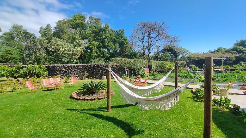 a hammock in the middle of a yard at Quinta dos Sentidos Eco Nature Retreat in Azores in São Vicente Ferreira