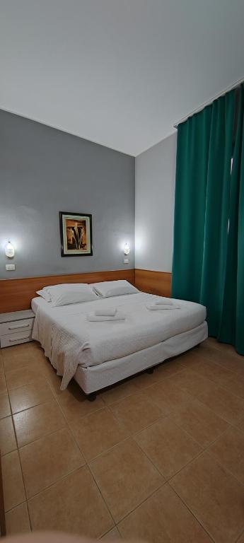 A bed or beds in a room at Hotel Nuovo Rondò