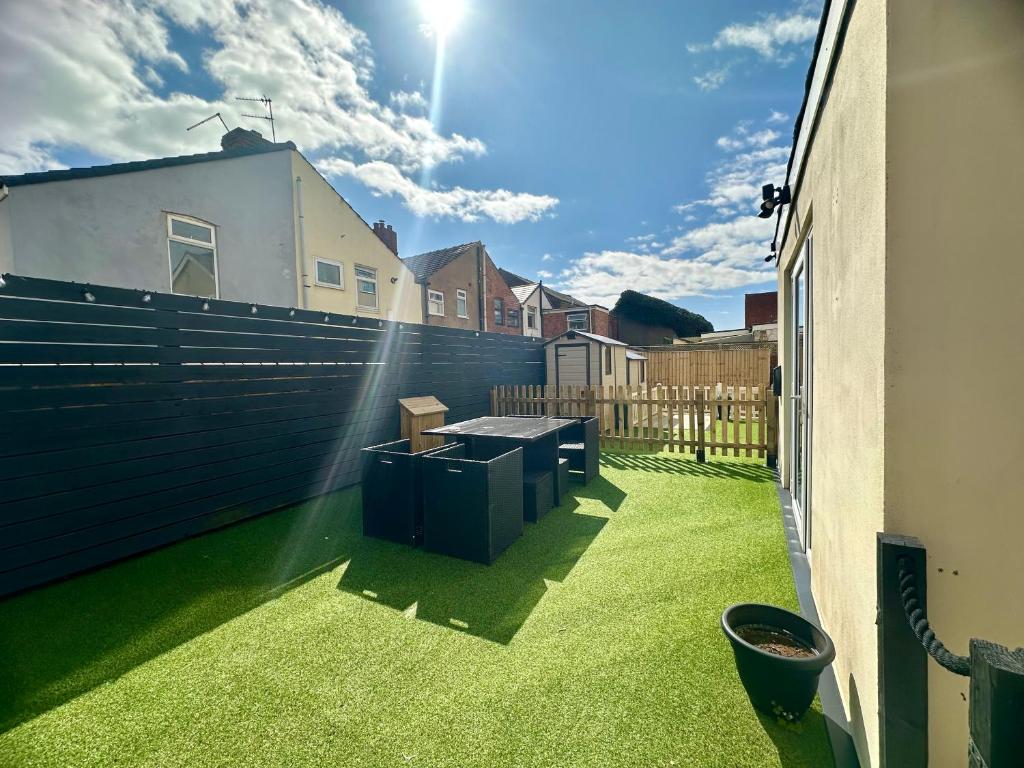 a balcony with a table on the grass at Sienna Family Holiday Apartments in Blackpool