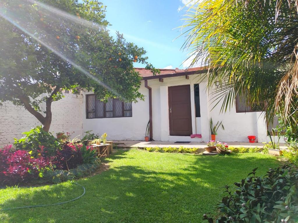 ein Haus mit einem grünen Hof mit einem Haus in der Unterkunft departamento en la mejor zona de cochabamba in Cochabamba