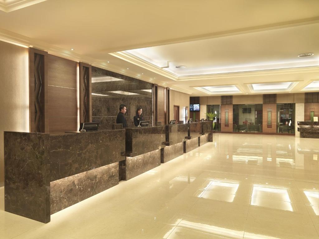 A spacious marble-floored reception lobby with multiple desks.