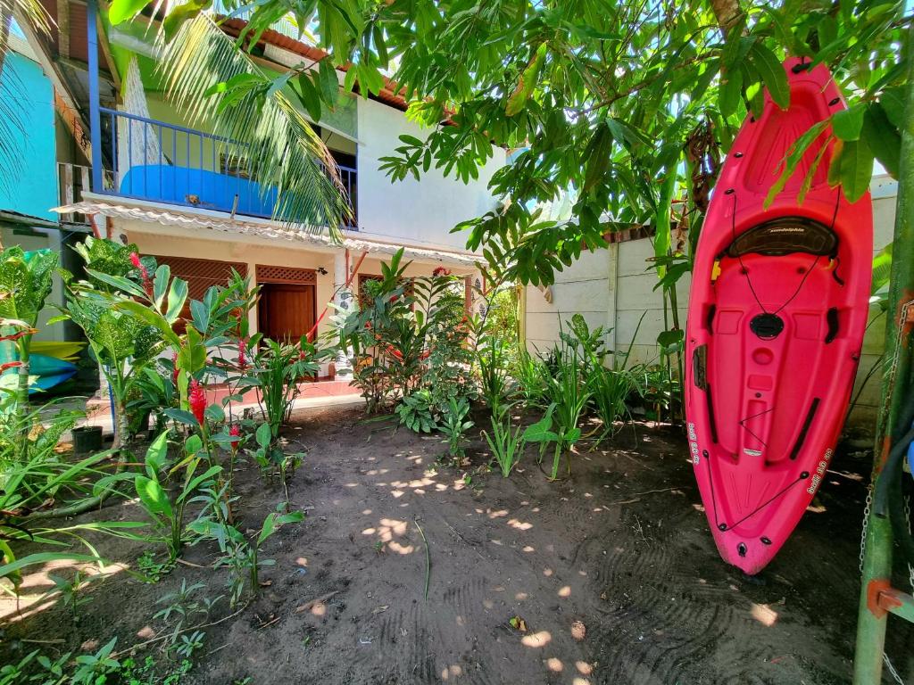 a red kayak sitting in front of a house at Wildlife Tortuguero in Tortuguero