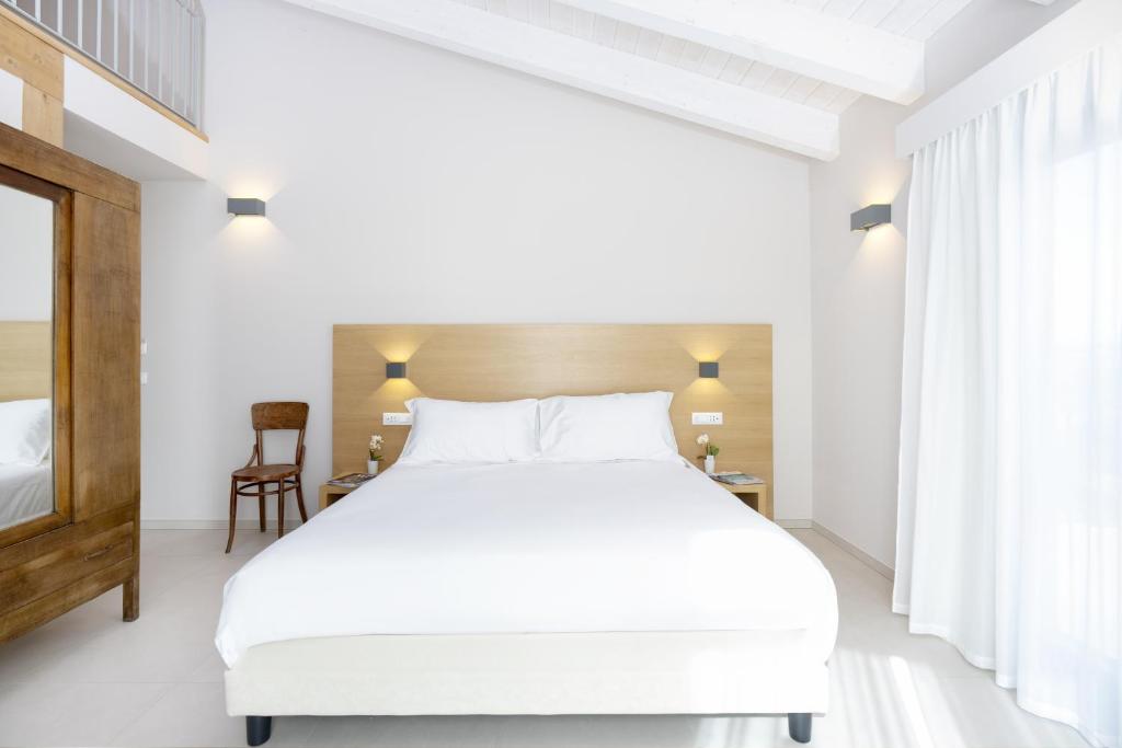 Postel nebo postele na pokoji v ubytování Ros'e Mari Green Home Hotel