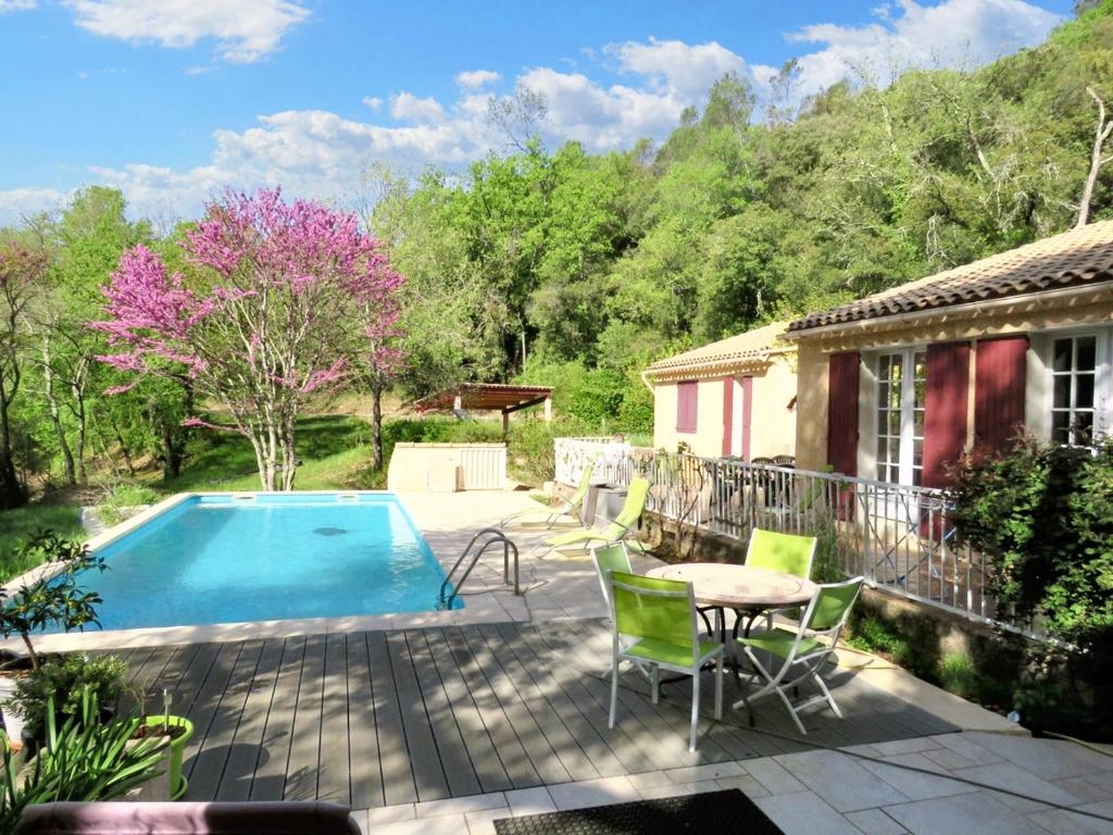 a patio with a table and chairs next to a pool at Villa de 2 chambres avec piscine partagee jardin amenage et wifi a Lorgues in Lorgues