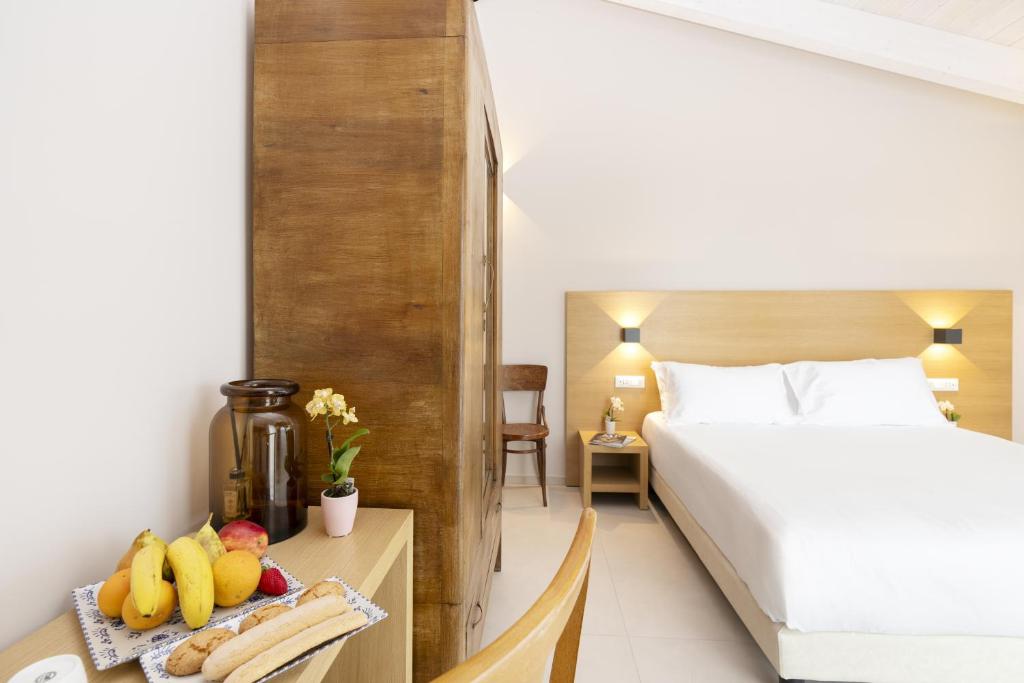 Postel nebo postele na pokoji v ubytování Ros'e Mari Green Home Hotel