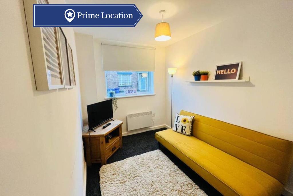 a living room with a yellow couch and a desk at Charming 1Bed Apt with Street Parking in Liverpool