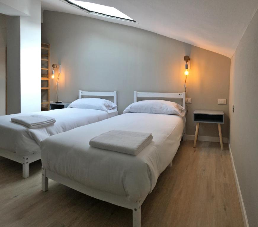 Postel nebo postele na pokoji v ubytování PASUBIO QUATTRO