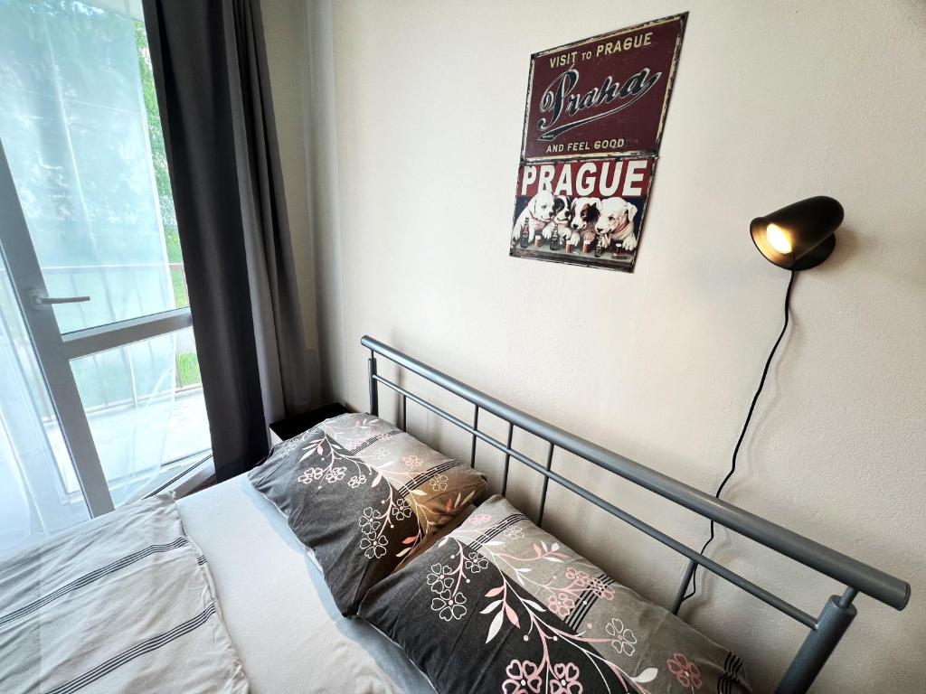 a bedroom with a bed and a movie poster on the wall at Hotel Penzion Rohožník in Prague