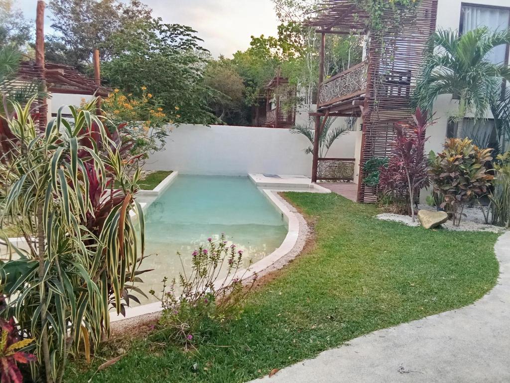 a swimming pool in the backyard of a house at AHAL in Chemuyil