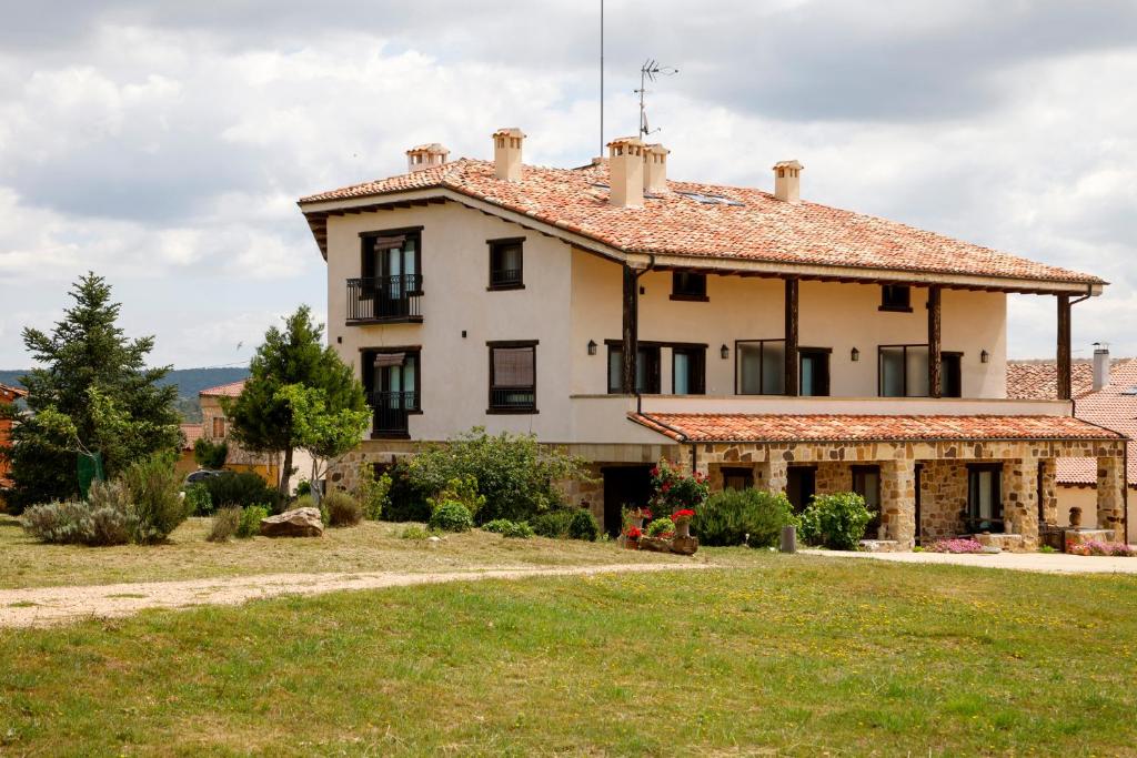 una casa grande con un gran patio delante en Hotel Valdelinares (Soria) en Valdelinares