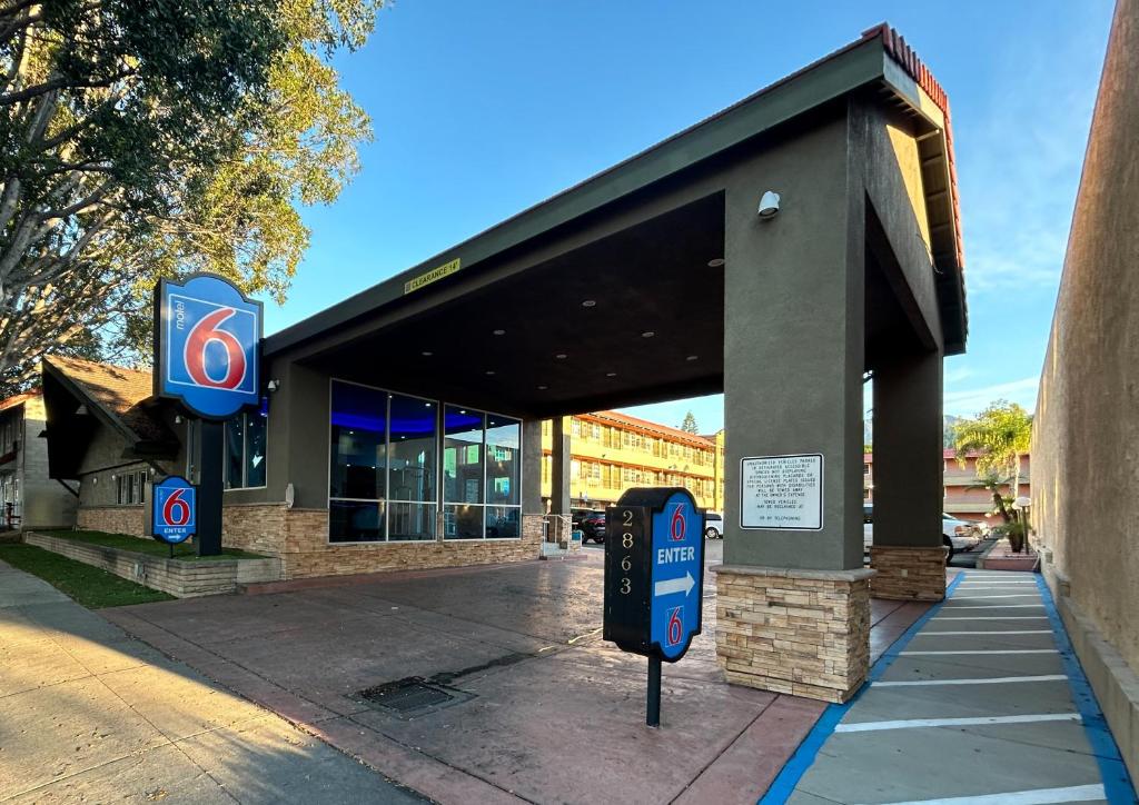 a gas station with a sign in front of it at Motel 6 Pasadena, CA Old Town Pasadena Area in Pasadena