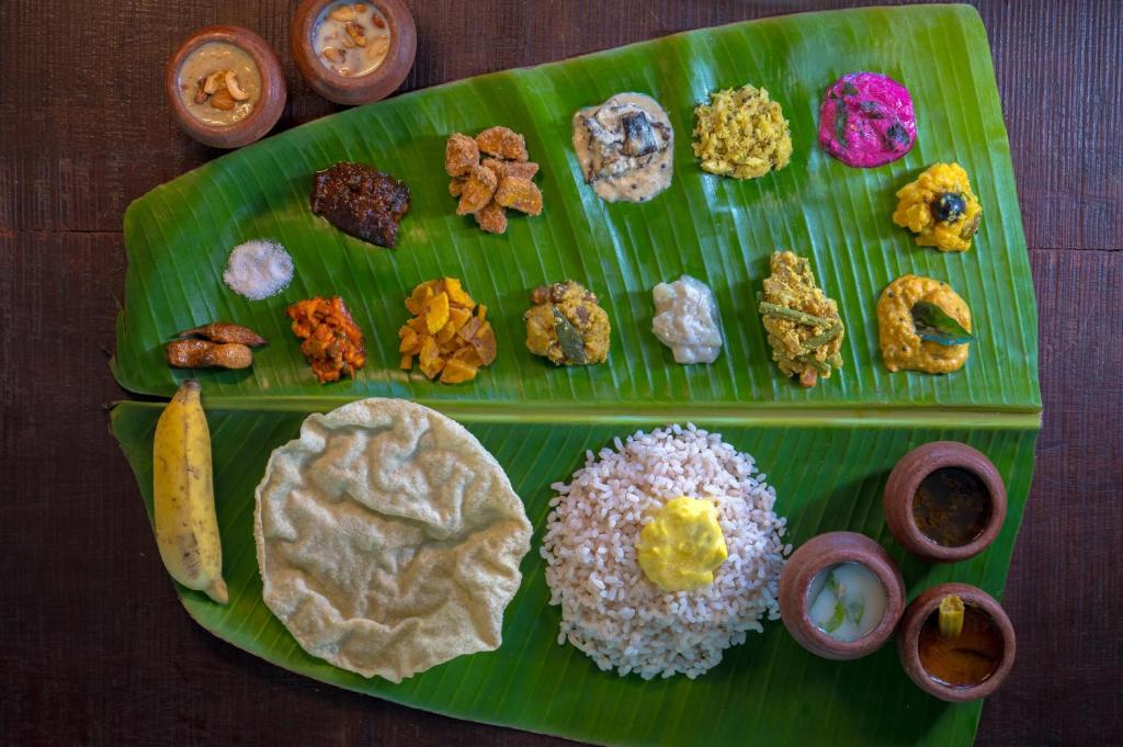 a plate of different types of food on a banana leaf at Sterling Wayanad in Sultan Bathery