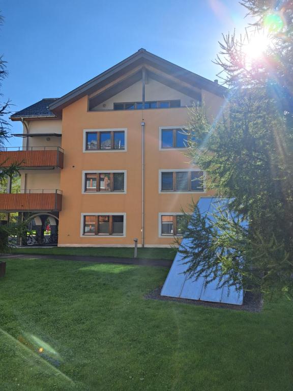a large building with a lawn in front of it at Chalet-Stil privat Zimmer 1-4 in Engelberg