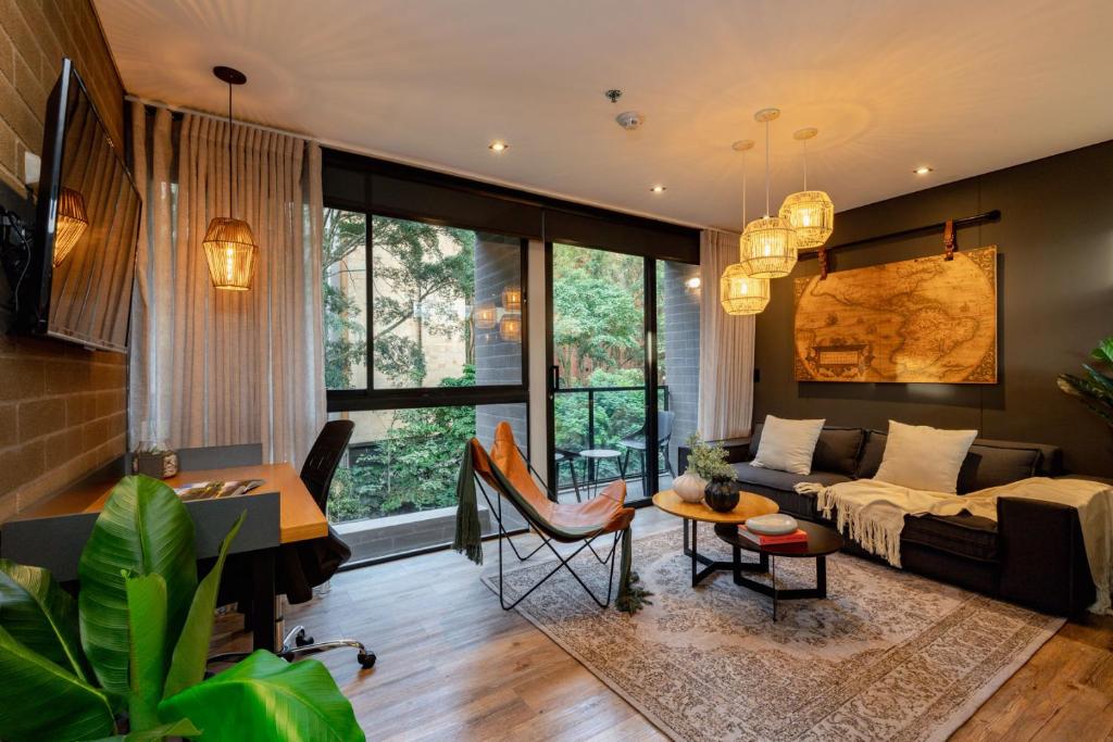 a living room with a couch and a table at Loma Verde Aparthotel in Medellín