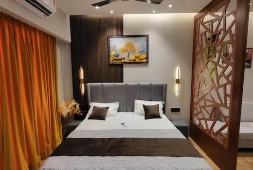 a bedroom with a large bed in a room at GT Stay Studio 1802 in Ghaziabad