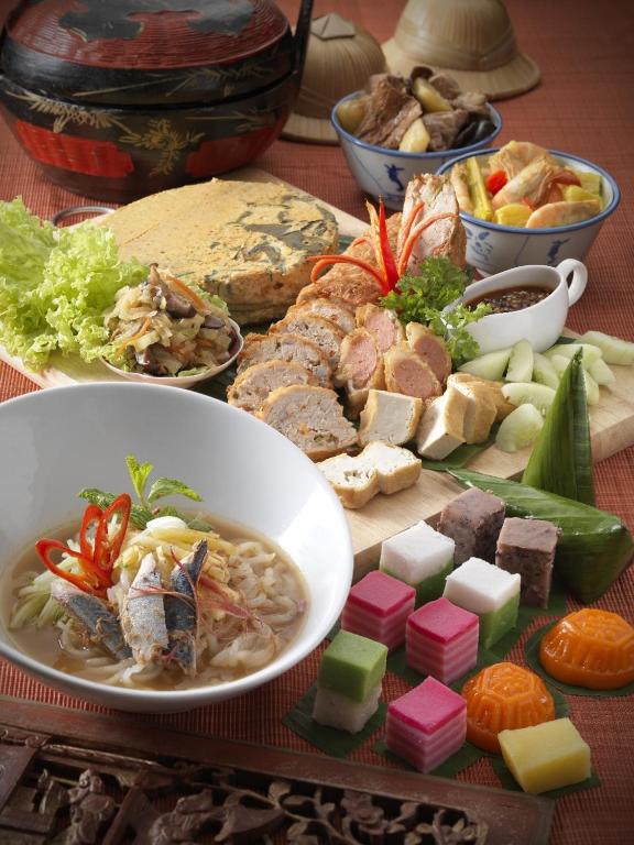 A close-up spread presents soup, carved meats, vegetables, sauces, and colourful desserts.