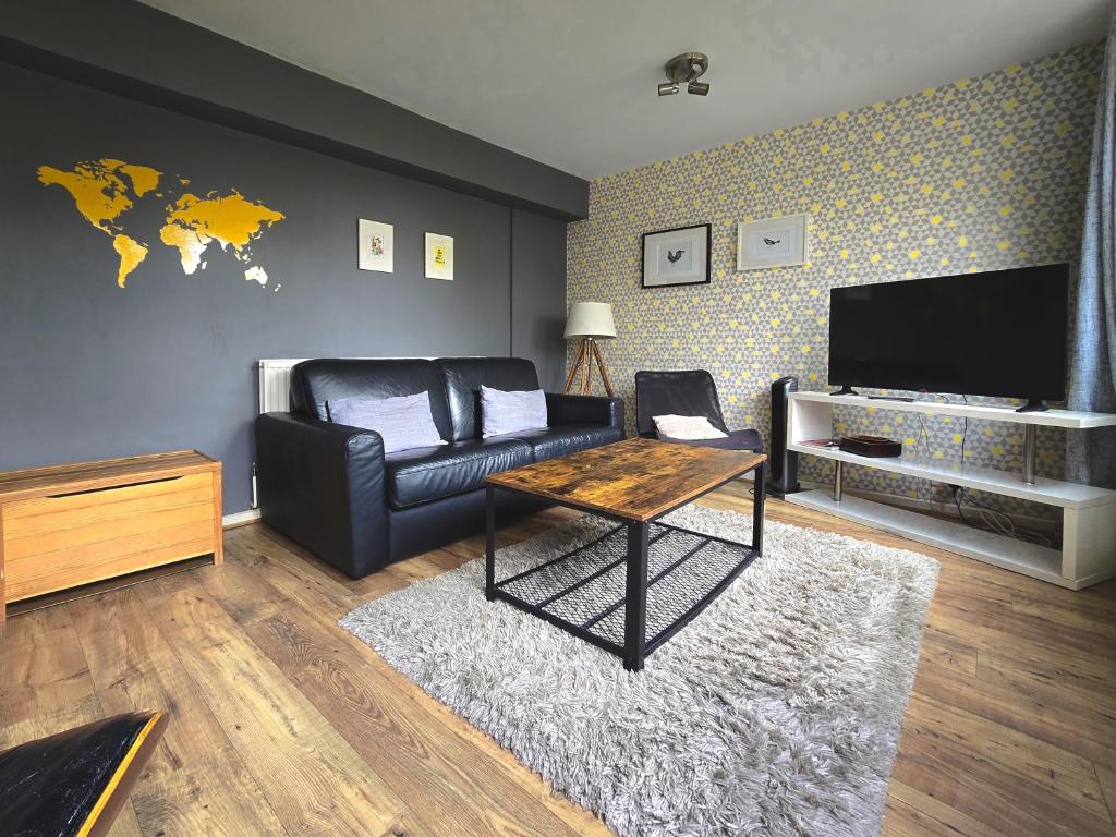 een woonkamer met een bank en een tafel bij Modern Central Family-Home for 6 in Londen