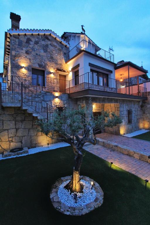 a house with a tree in front of it at Apartamentos La Vera de Gredos in Villanueva de la Vera