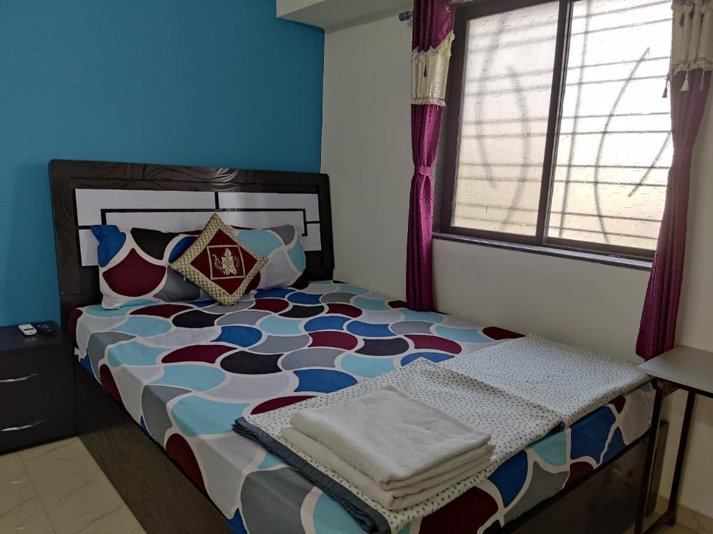 Postel nebo postele na pokoji v ubytování Ambient Homestay by NESTEASY