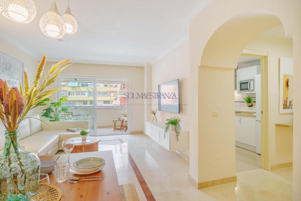 a living room with a couch and a table at Mar y Puerto Best Location by Sol Maestranza in Marbella