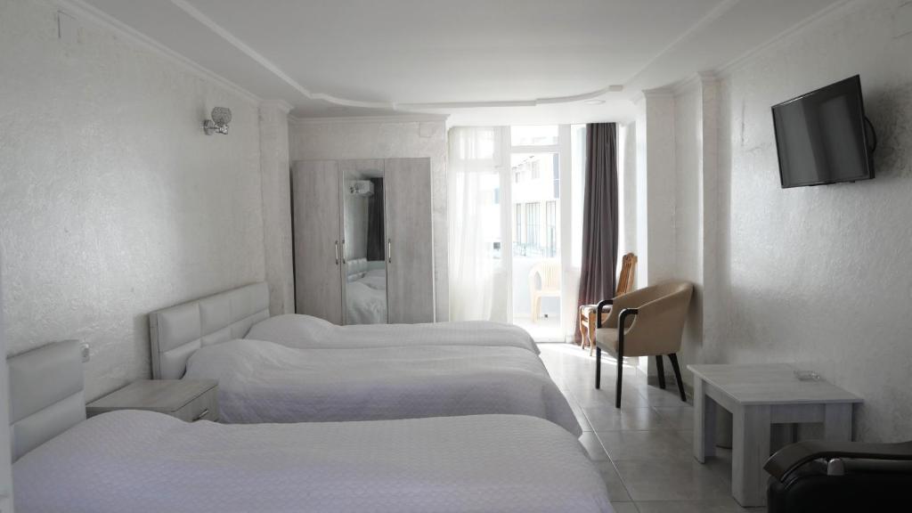 Postel nebo postele na pokoji v ubytování Mariam Hotel