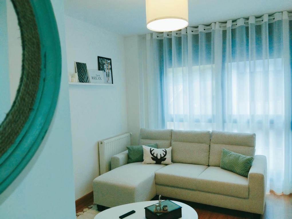 a living room with a couch and a table at La Berrea Cabañaquinta in Aller