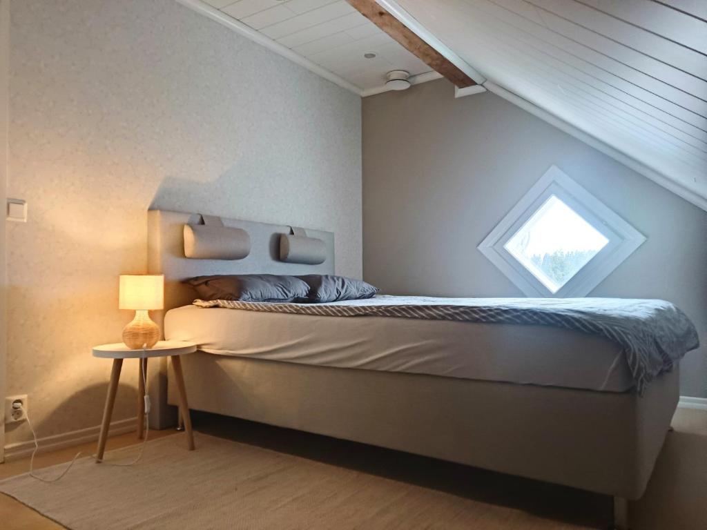 een slaapkamer met een bed en een raam bij The House in Lahti