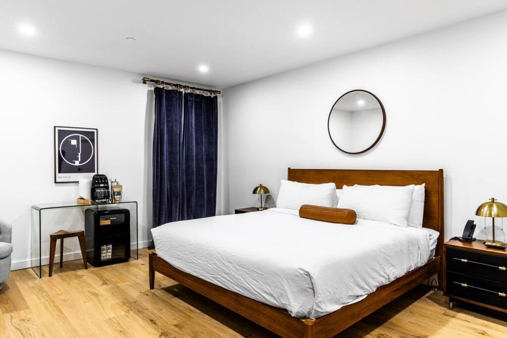 a bedroom with a large bed and a mirror at King Bed , DTWN, 50 in Roku TV , Fiber Internet, Room # 203 in Bangor