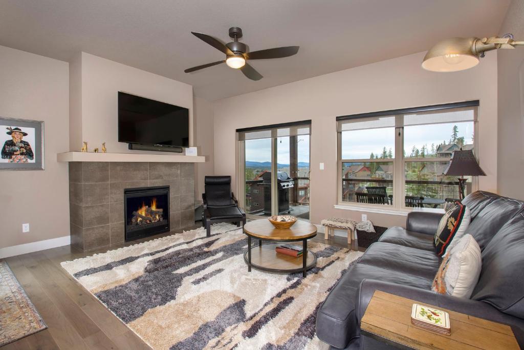 a living room with a couch and a fireplace at Rendezvous 47 Lookout Point in Fraser