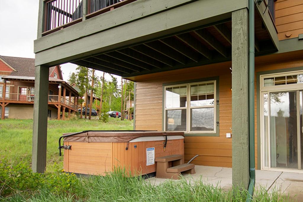 a porch of a house with a hot tub at 45 Reunion Court - Rendezvous in Fraser
