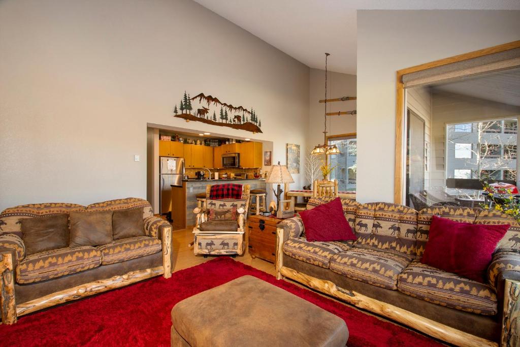 a living room with two couches and a kitchen at Snowblaze Condos Building C unit 24 in Winter Park