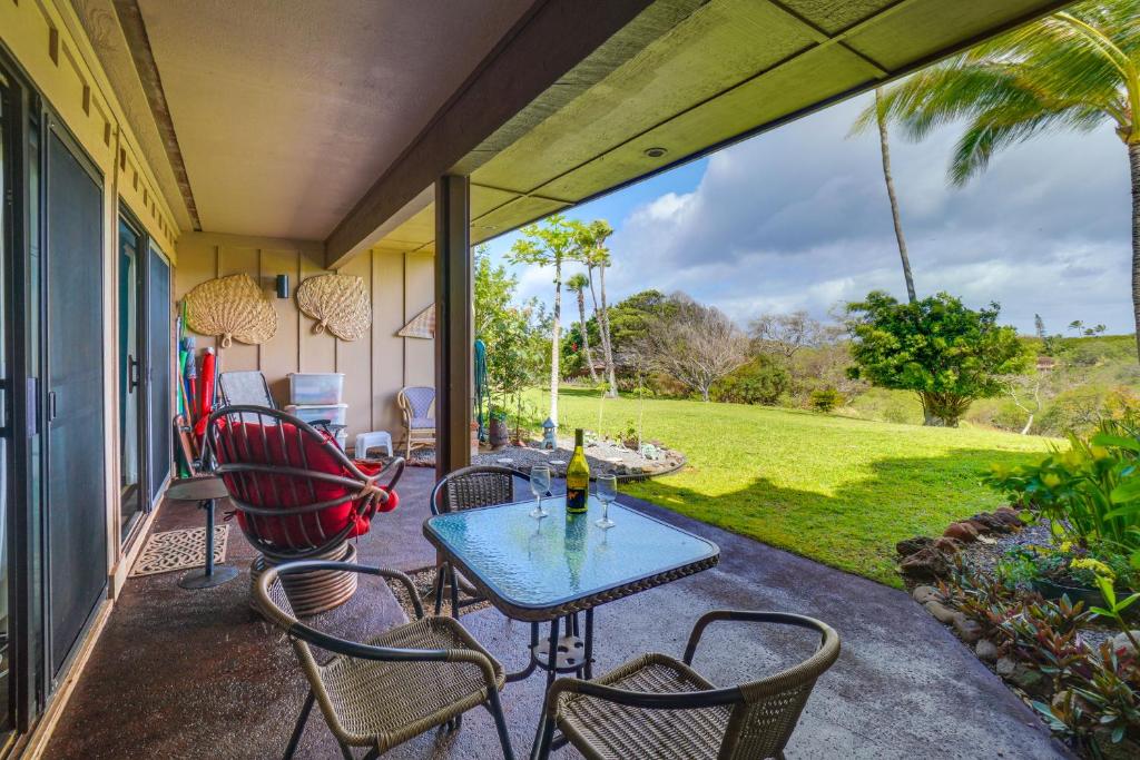 un patio con mesa y sillas en un porche en Peaceful Condo with Amenities Steps to Beach! en Maunaloa