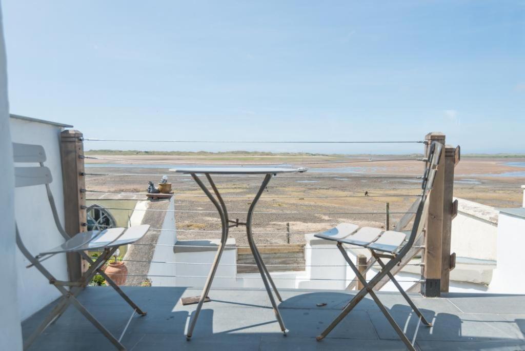 a table and two chairs on a balcony with a view at 2 Bed in Ravenglass SZ409 in Ravenglass