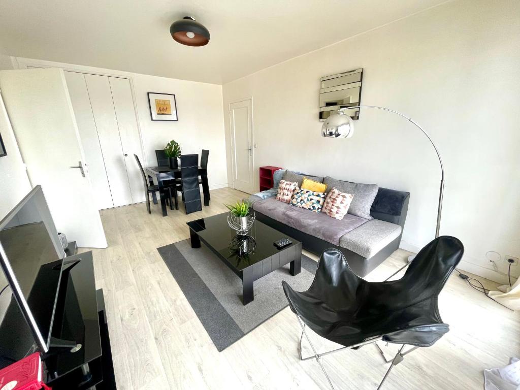 un salon avec un canapé et une table dans l'établissement PARIS centre ville lumière Tour Eiffel, à Paris