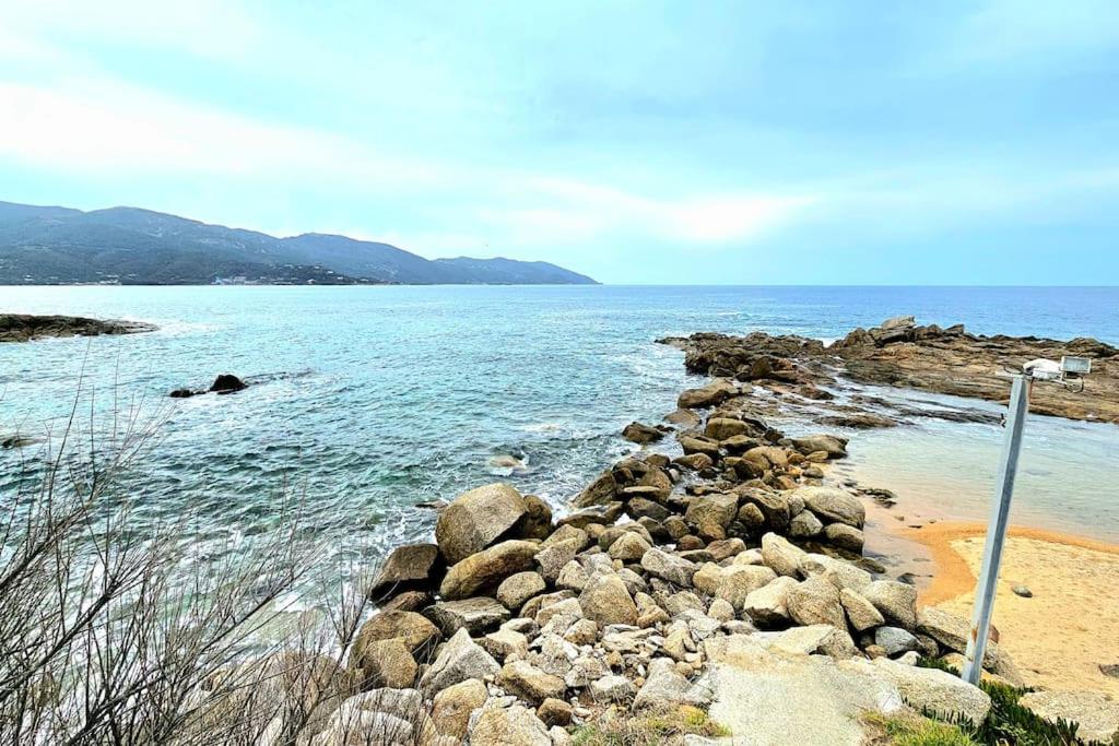 a group of rocks on a beach near the water at Nouveau Superbe appartement - Rsd Calypso Tiuccia in Casaglione