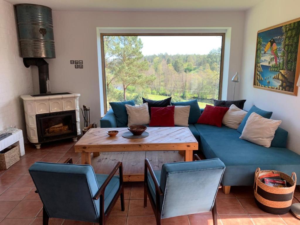 a living room with a blue couch and a table at Dom Mossa in Stara Rzeka