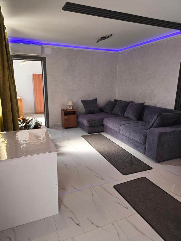 a living room with a couch and a table at Terra Residence Beiuș in Beiuş