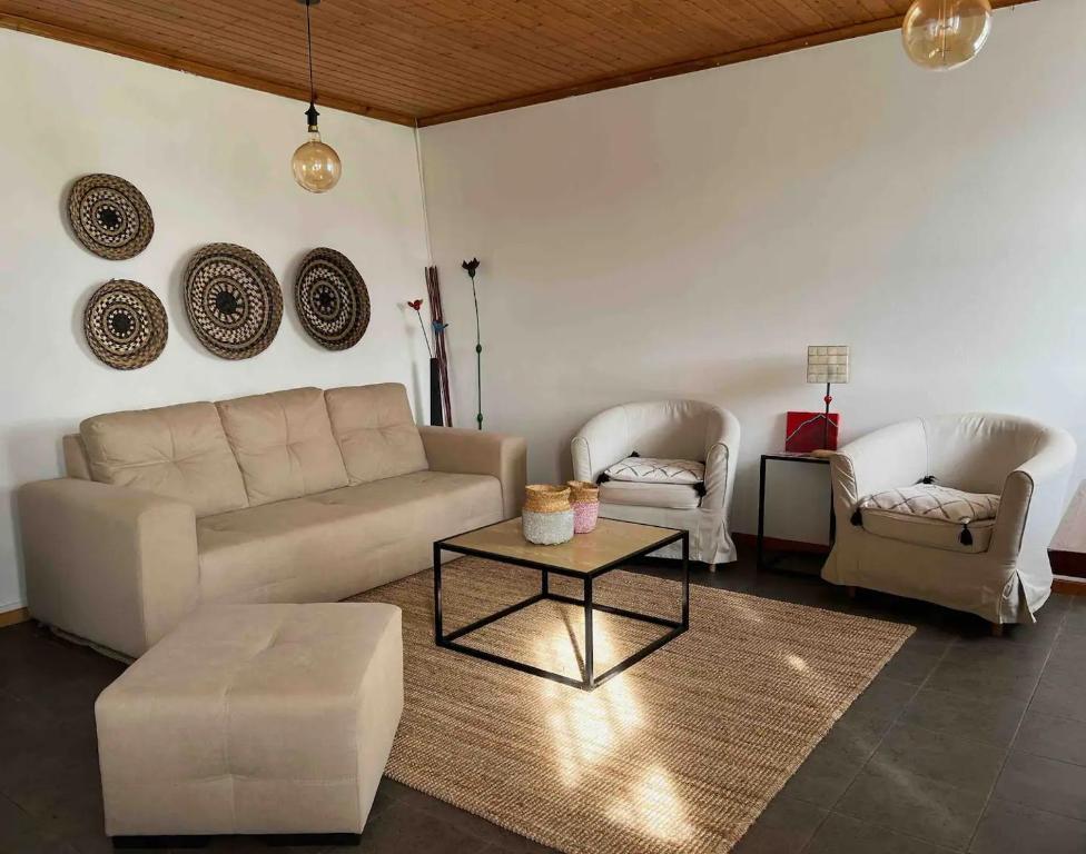 a living room with a couch and two chairs and a table at Casa do Cacto - 1 Bedroom Flat in Madalena