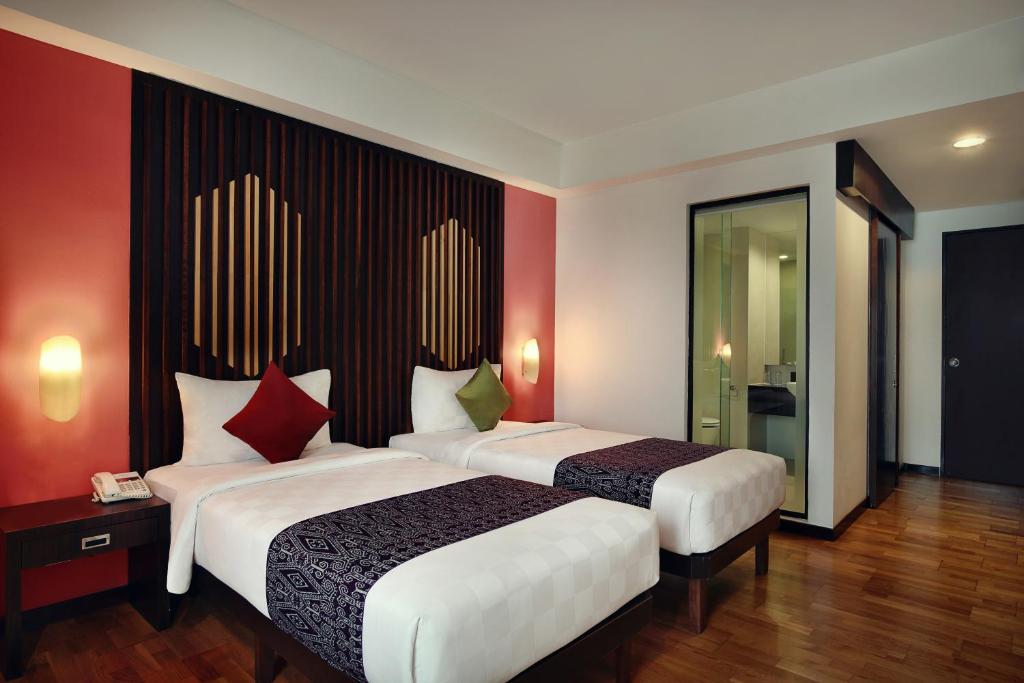 Postel nebo postele na pokoji v ubytování Mercure Pontianak City Center