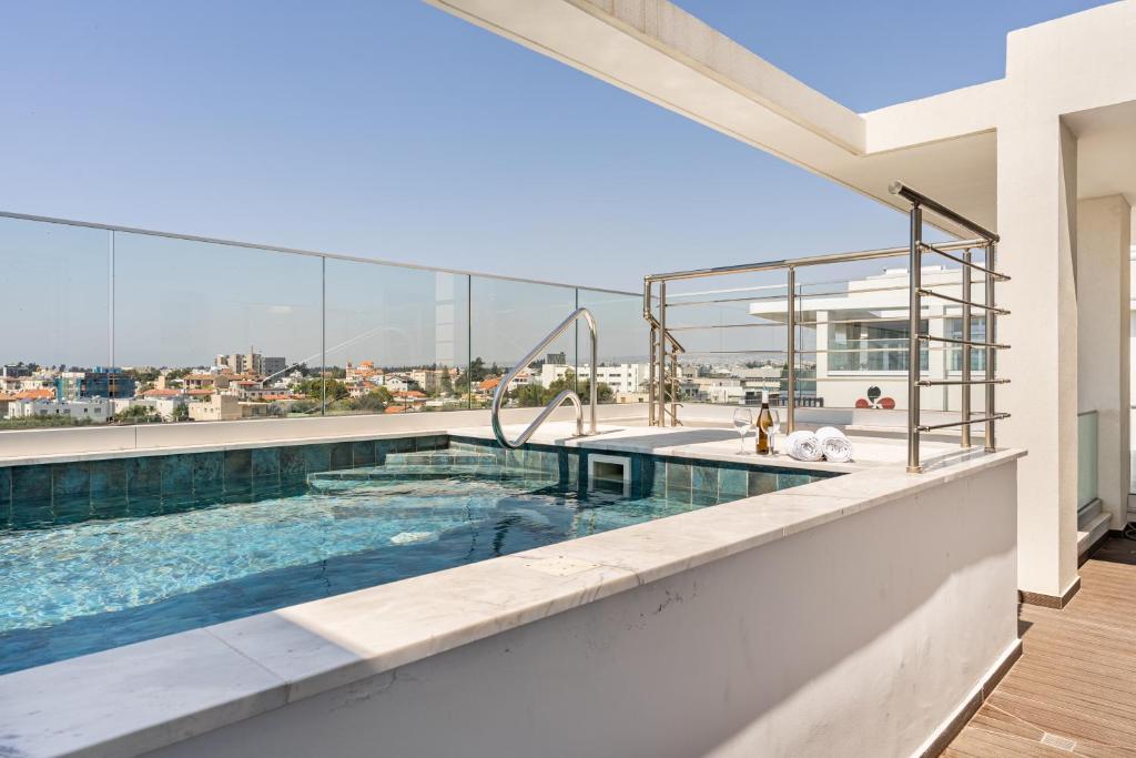 a swimming pool on the roof of a building at YAMAS Urban Living Pool Penthouse Marvel in Limassol